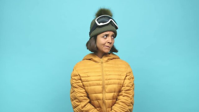 Young snowboard indian woman confused, feels doubtful and unsure