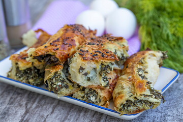 Traditional Turkish pastry with spinach. (Turkish Name: Ispanakli Kol Boregi, Bosnak boregi). Handmade pastry with spinach filling.