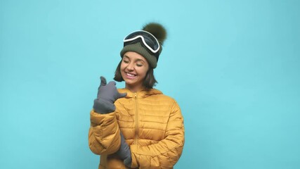 Young snowboard indian woman showing a mobile phone call gesture with fingers