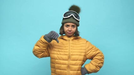 Young snowboard indian woman showing a dislike gesture, thumbs down. Disagreement concept.