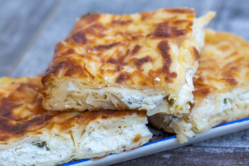 Su Boregi / Turkish Patty on wooden surface.
