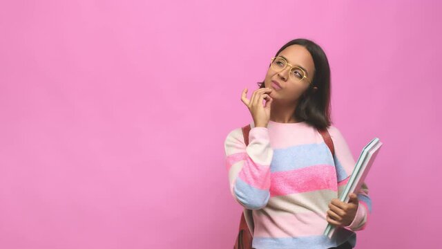 Young student indian woman looking sideways with doubtful and skeptical expression