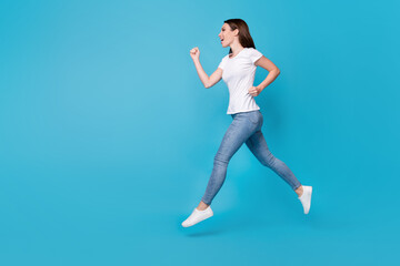 Fototapeta na wymiar Full length body size view of her she nice attractive purposeful slim fit thin skinny cheerful girl jumping running sprint action comfort isolated bright vivid shine vibrant blue color background