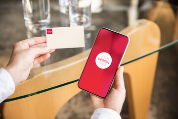 Hands holding devices or gadgets with copyspace for ad - mockup, digital concept. Office or co-working location with highly digital workplace, top view. Online work, shopping, service concept.