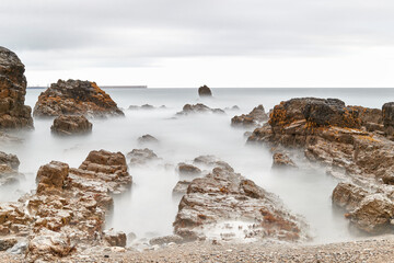 Long exposure photography with a neutral density filter. Beach in Asturias, Spain with a cloudy...