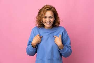 Young Georgian woman isolated on pink background with surprise facial expression