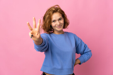 Young Georgian woman isolated on pink background happy and counting three with fingers