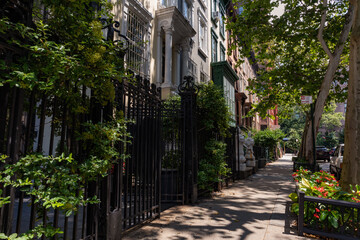 Fototapeta na wymiar Row of Old Brownstone Homes on the Upper West Side of New York City with an Empty Sidewalk