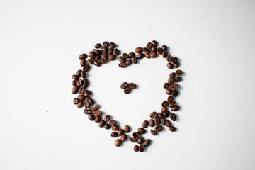 Grains of coffee on a white background. Different shapes made from grains