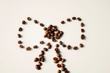 Grains of coffee on a white background. Different shapes made from grains