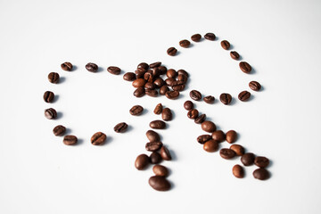 Grains of coffee on a white background. Different shapes made from grains
