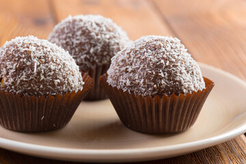 Chocolate balls in coconut shavings close up