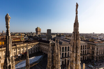 Aerial view of Milan Italy from Cathedral Duomo rooftop terrace with statue