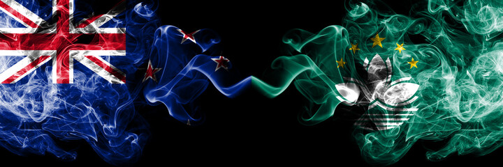 New Zealand vs Macau, China smoky mystic flags placed side by side. Thick colored silky abstract smoke flags