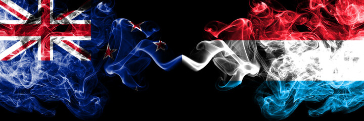 New Zealand vs Luxembourg smoky mystic flags placed side by side. Thick colored silky abstract smoke flags