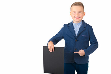 Happy exited caucasian young boy showing and displaying blank black board ready for your text or...