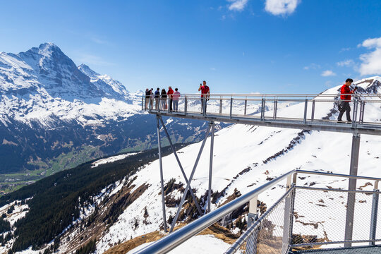 Traveller are resting and photograph on sky cliff walk at First peak of Alps mountain Grindelwald Switzerland