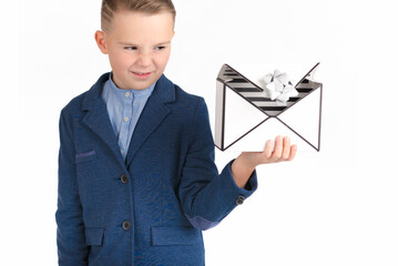 European boy in a blue costume looks at the empty gift box with disgust.White background.