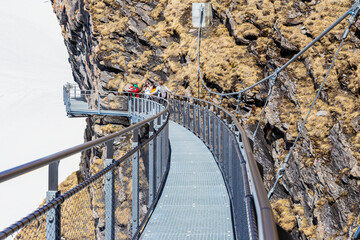 Traveller are resting and photograph on sky cliff walk at First peak of Alps mountain Grindelwald...