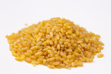 Heap of dry bulgur isolated on white