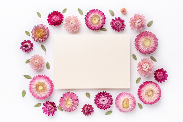 Flower composition. Blank of paper and frame made of dry flowers on white background. Flat lay. Top view. Copy space