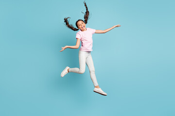 Full length body size view of her she nice attractive pretty funky childish playful comic foolish cheerful cheery girl jumping having fun fooling isolated over blue pastel color background