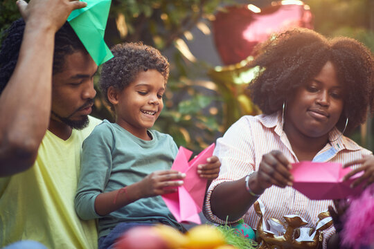 Afro-american Mom And Dad  Playing With Their Son At Birthday Party. Parenting, Bond Concept