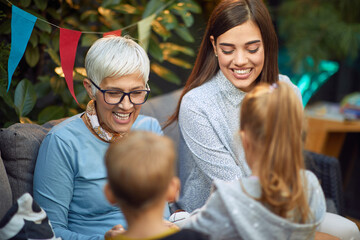 brother and sister with their mom and grandma