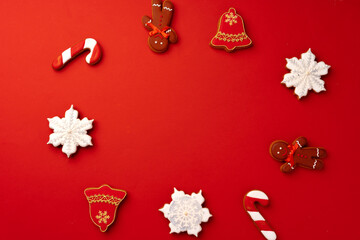 Christmas gingerbread cookies on red background top view