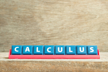 Tile letter on red rack in word calculus on wood background