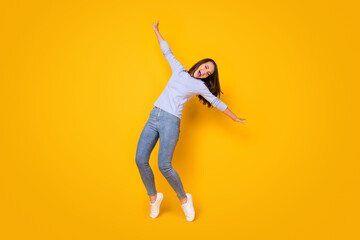 Fototapeta na wymiar Full length body size view of her she attractive pretty overjoyed dreamy cheerful cheery girl jumping having fun dancing singing chill isolated bright vivid shine vibrant yellow color background