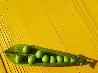 green peas on wooden background