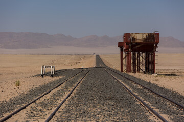 Fototapeta na wymiar Abandoned and forgotten railway being taken over by encroaching sandstorm, Kolmanskop ghost town, Namib Desert. Africa