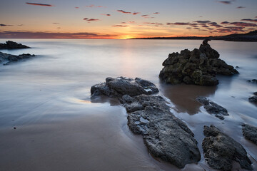 Landscape of an orange sunrise at Liencres beach