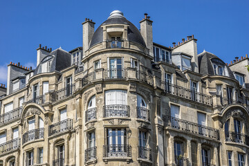 Architecture of Paris: Old French house with traditional balconies and windows. Paris, France.