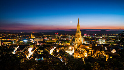 Germany, Freiburg im Breisgau, Magical blue hour atmoshpere of the illuminated skyline and minster...