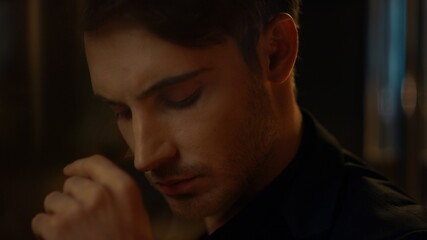 Focused man face raising head camera indoors. Serious top manager pondering