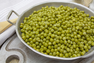 plat de petits pois cuits sur une table en bois