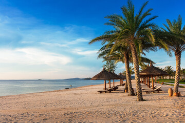 Obraz na płótnie Canvas sun loungers and parasols on sandy beach