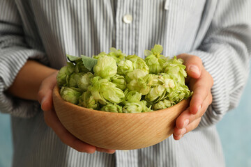 Woman hold bowl with hop, front view