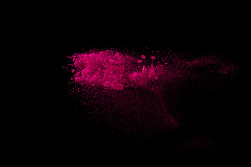 Pink powder explosion on black background. Paint Holi.