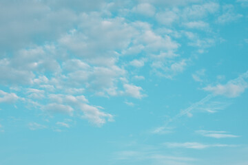 Fototapeta na wymiar Just plain blue skies and fluffy clouds