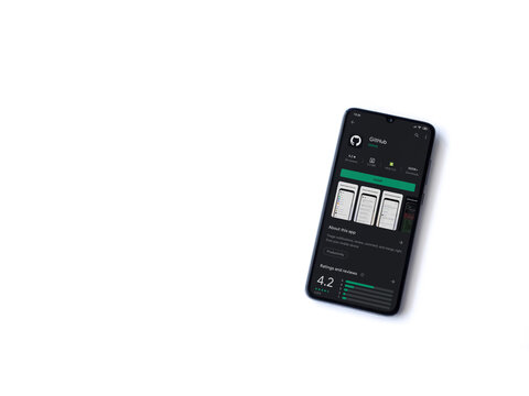 Lod, Israel - July 8, 2020: GitHub app play store page on the display of a black mobile smartphone isolated on white background. Top view flat lay with copy space.