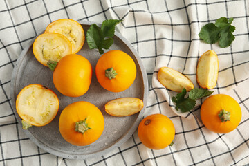 Tray with round zucchini on napkin background