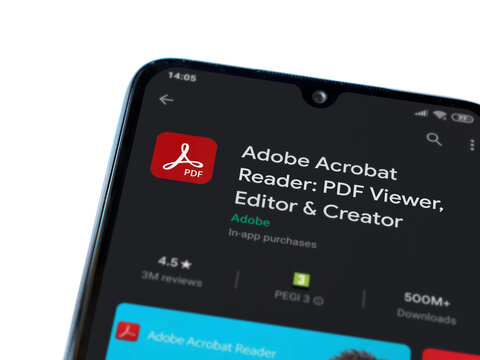 Lod, Israel - July 8, 2020: Adobe Acrobat Reader app play store page on the display of a black mobile smartphone isolated on white background. Top view flat lay with copy space.