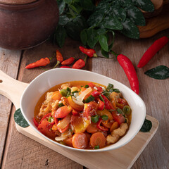 Chinese food chicken soup served on a plate with chilies  on the side