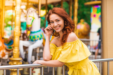 Obraz premium Happy beautiful redhead girl walking in the park