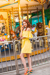 Happy beautiful redhead girl walking in the park