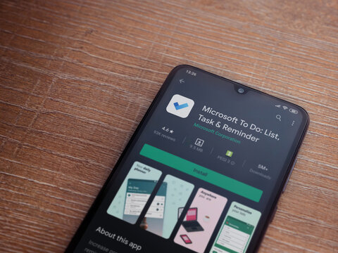 Lod, Israel - July 8, 2020: Microsoft To Do app play store page on the display of a black mobile smartphone on wooden background. Top view flat lay with copy space.