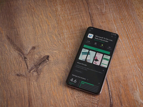 Lod, Israel - July 8, 2020: Microsoft To Do app play store page on the display of a black mobile smartphone on wooden background. Top view flat lay with copy space.